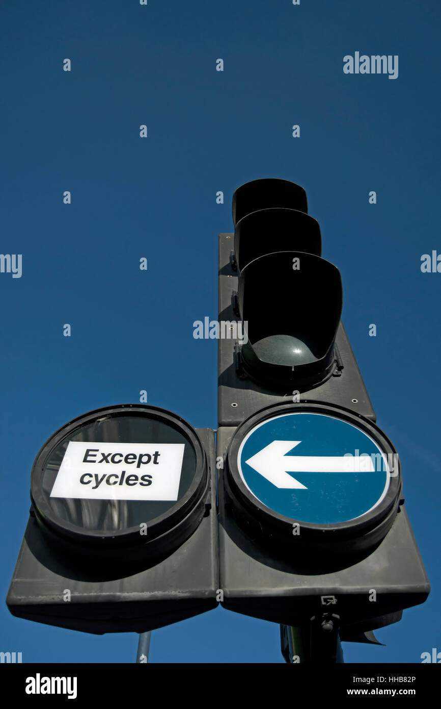 british traffic lights with signs indicating a mandatory left turn