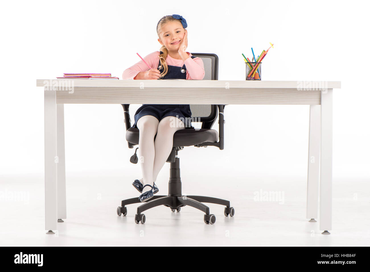Schoolgirl sitting desk school smiling hi-res stock photography and ...
