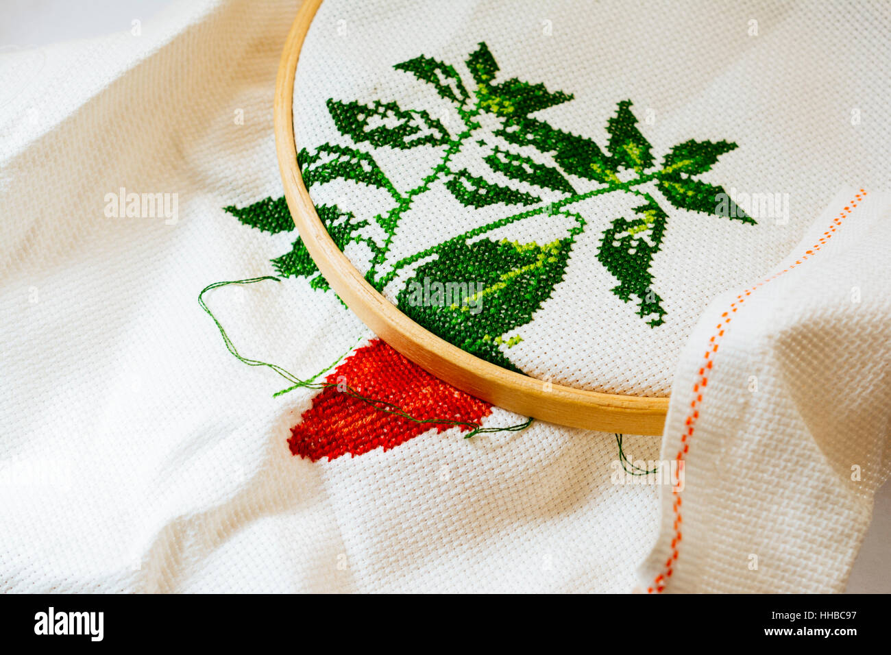 Cross-stitch is a popular form of counted-thread embroidery in which X-shaped stitches in a tiled, raster-like pattern are used to form a picture. Stock Photo