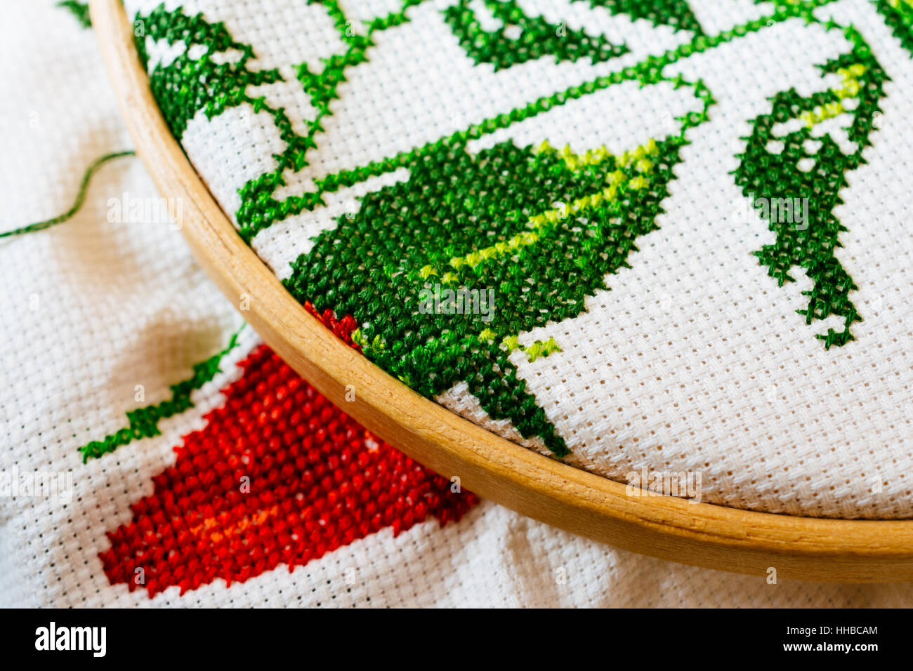 Cross-stitch is a popular form of counted-thread embroidery in which X-shaped stitches in a tiled, raster-like pattern are used to form a picture. Stock Photo