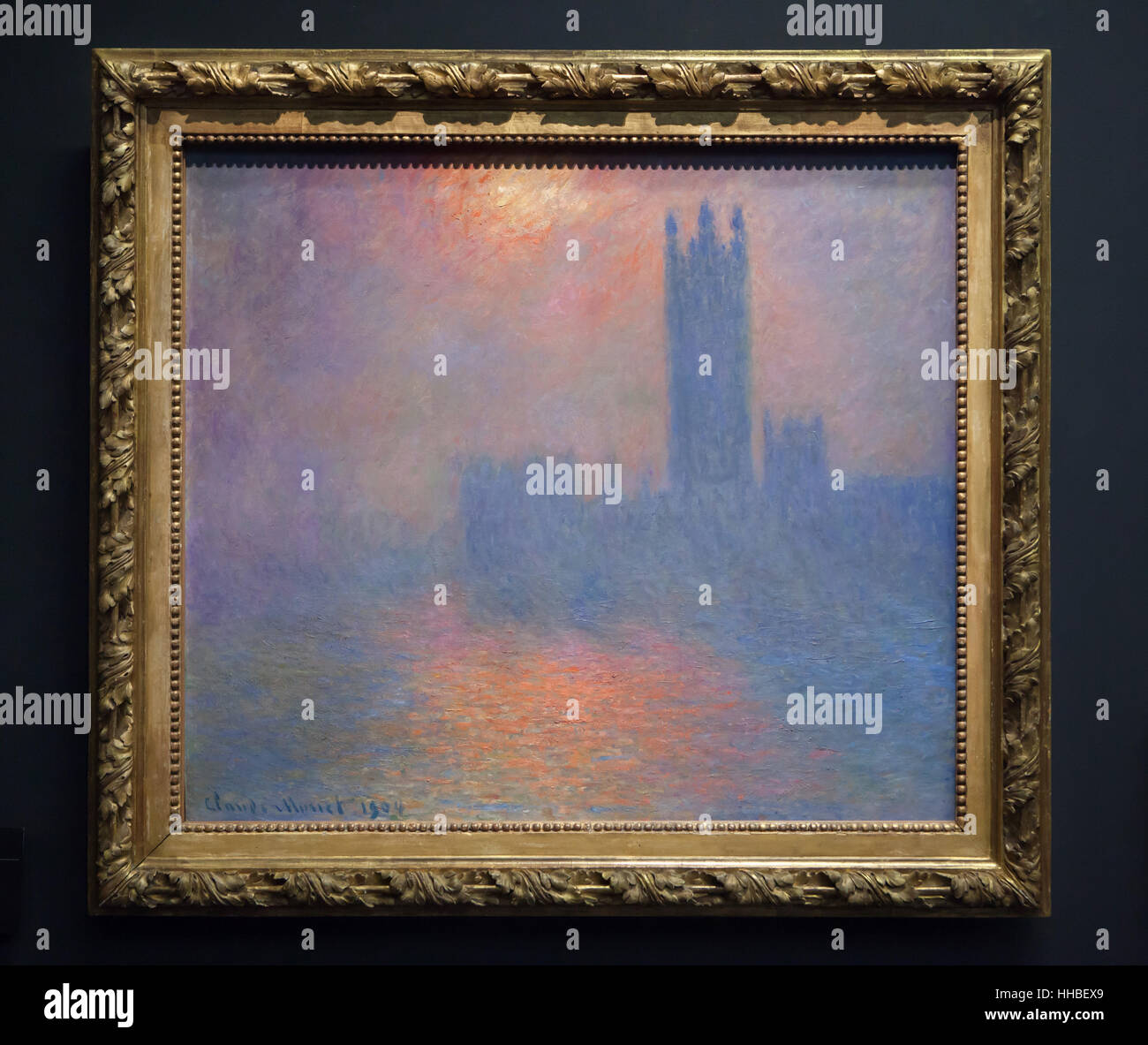 Painting from the series Parlements de Londres (Houses of Parliament) by French Impressionist painter Claude Monet displayed in Musee d'Orsay in Paris, France. The complete title of the painting: Houses of Parliament, London, Sun Breaking through the Fog (1904). Stock Photo