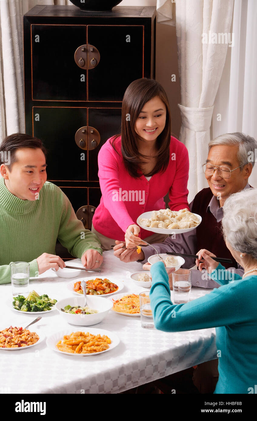 Family at dinner table having traditional food Stock Photo - Alamy