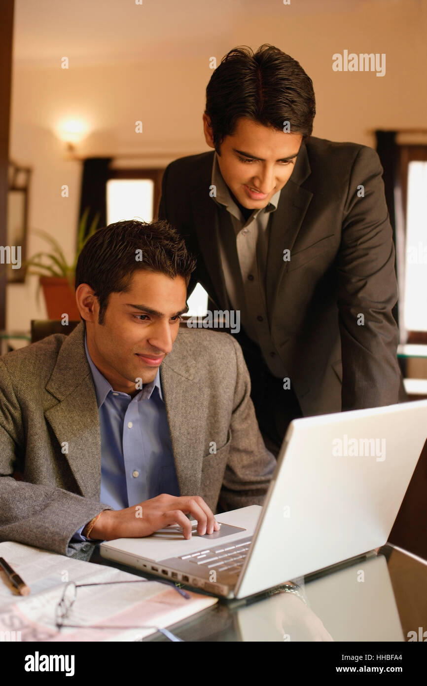two men working at laptop Stock Photo - Alamy