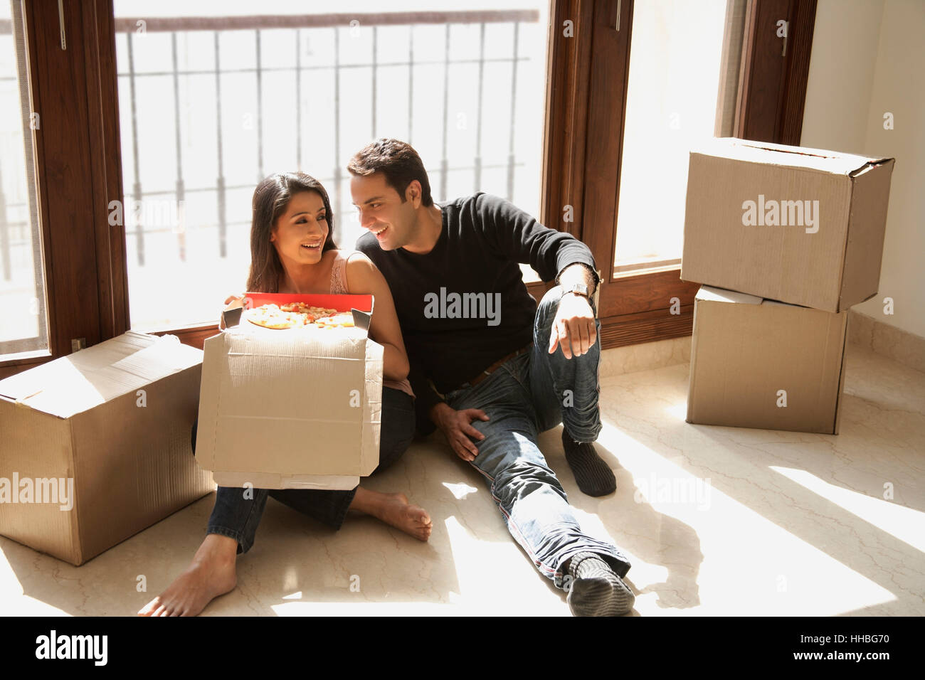 young couple in new home with moving boxes Stock Photo - Alamy