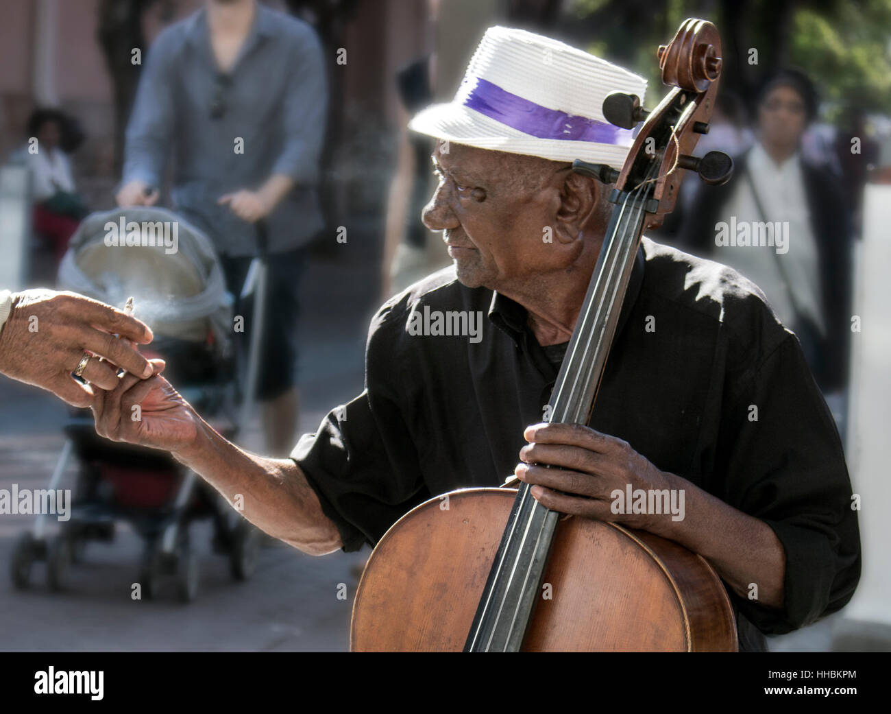 Street musician sharing a cigarette, Waterfront, Cape Town. Stock Photo