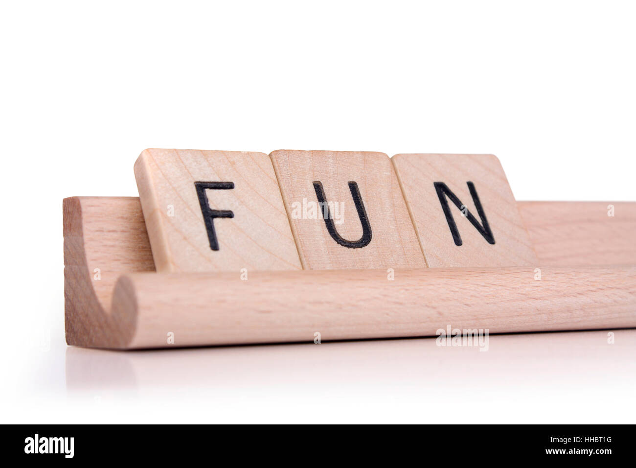 Wooden game tiles on a rack spelling out the word "fun Stock Photo Alamy