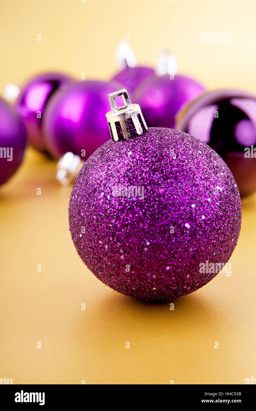 purple baubles christmas decorations on golden background Stock Photo