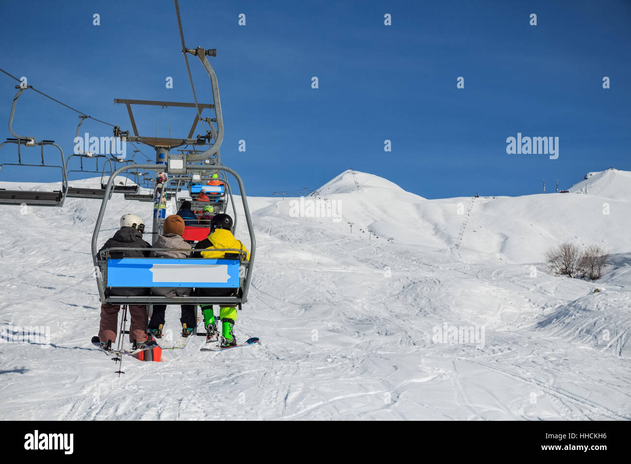 Skiers on a ski lift Stock Photo - Alamy