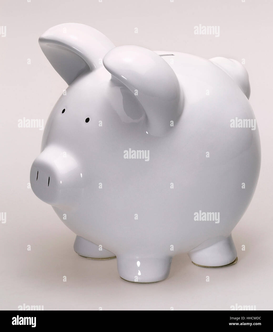a clean white porcelain piggybank in light back Stock Photo