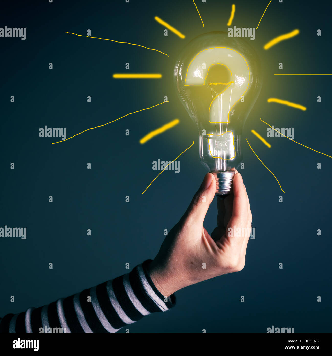 Hand with light bulb and question mark for innovation, inspiration, creativity, brainstorming, new ideas and imagination concept Stock Photo