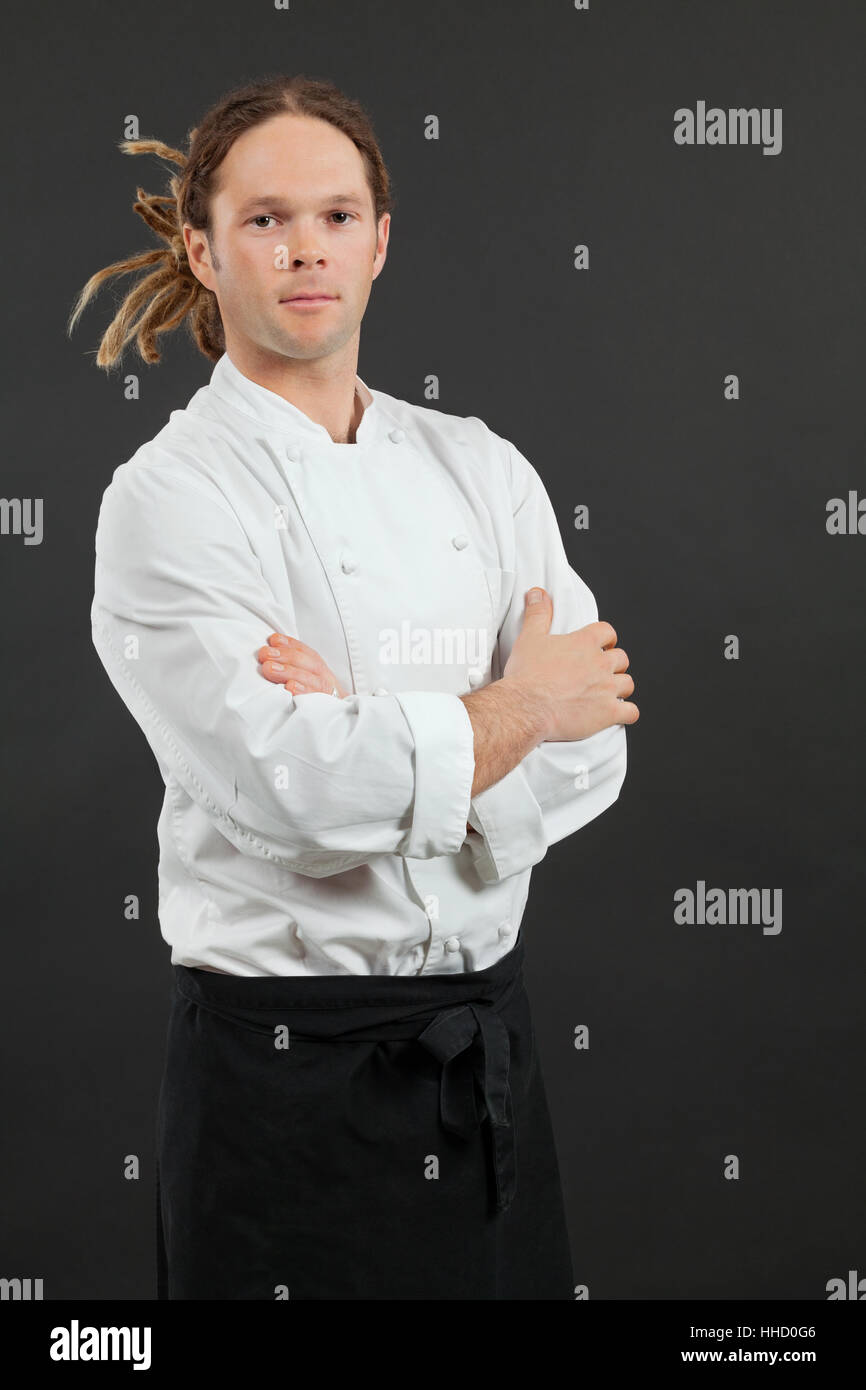 Serious chef with arms crossed, symbolizing the need for clear, authoritative signage like printable first aid signs in the workplace