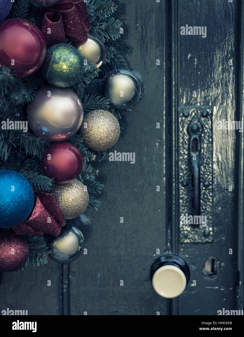 Beautiful close up of old fashioned retro vintage style Christmas wreath hanging on wooden door Stock Photo