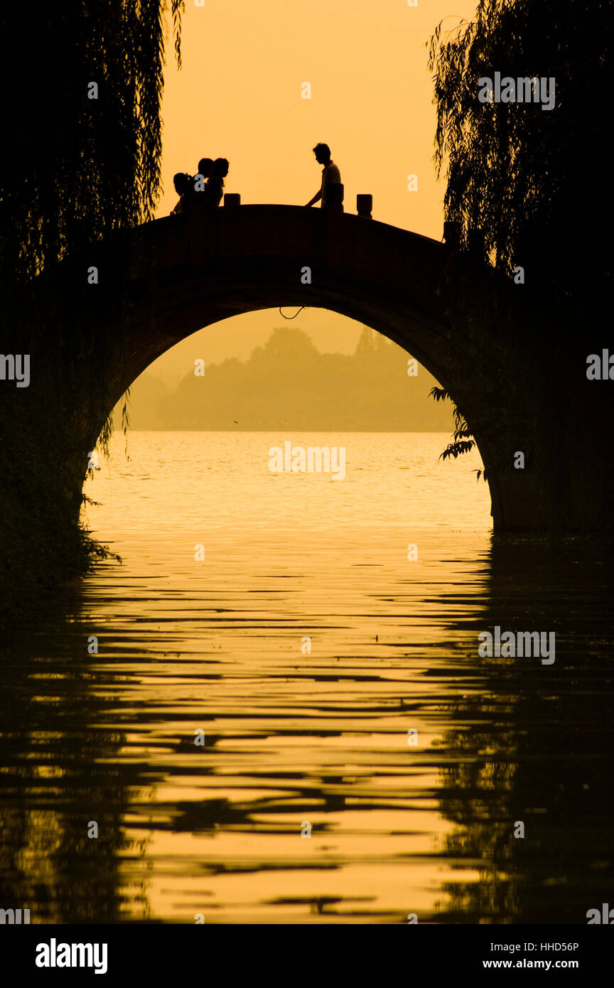 silhouette of people walking on the bridge in xihu,hangzhou Stock Photo ...