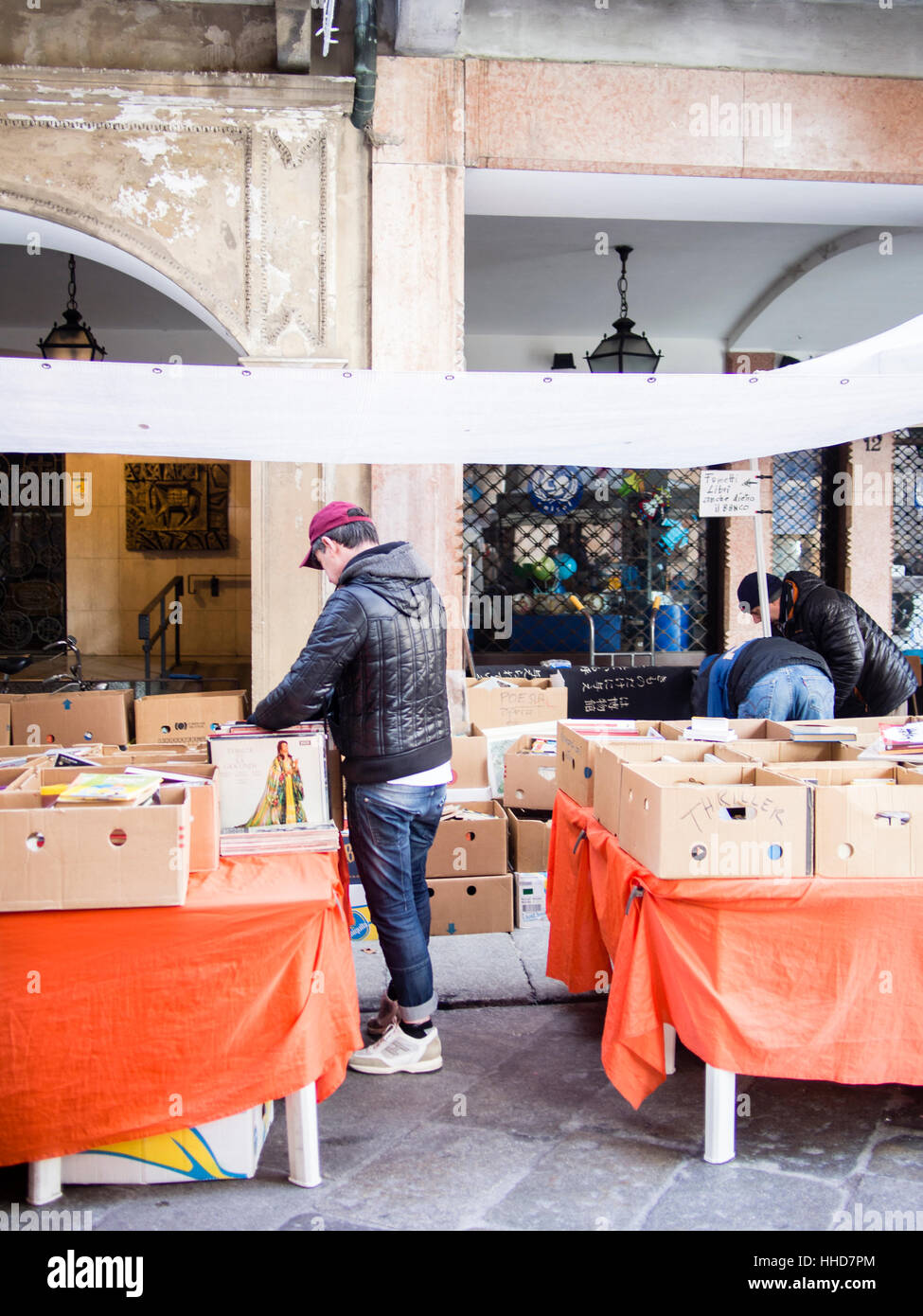Book seller in street market, winter time, Lombardy, Italy Stock Photo