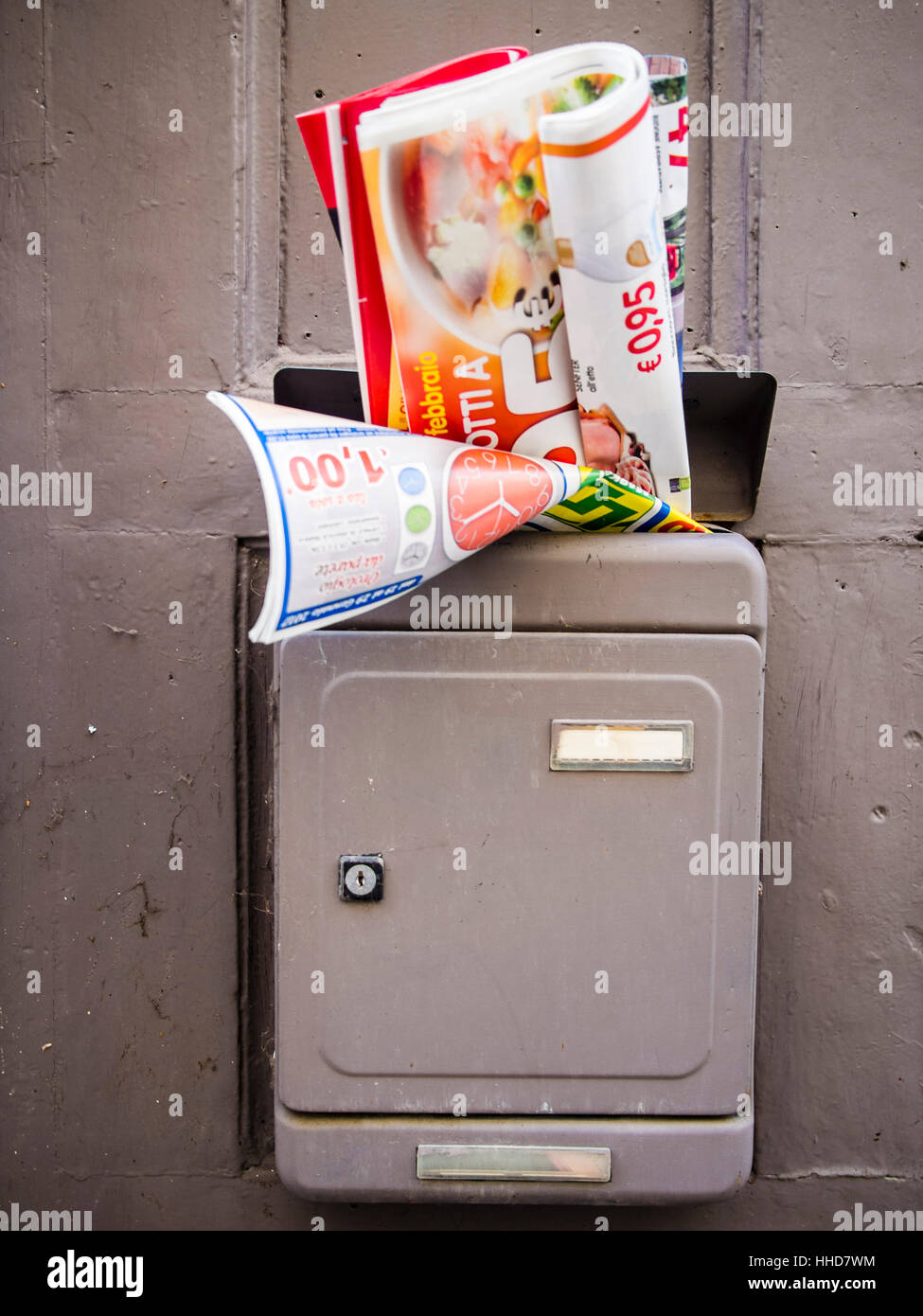 Junk mail in door handle or posto boxes in Italy. Stock Photo