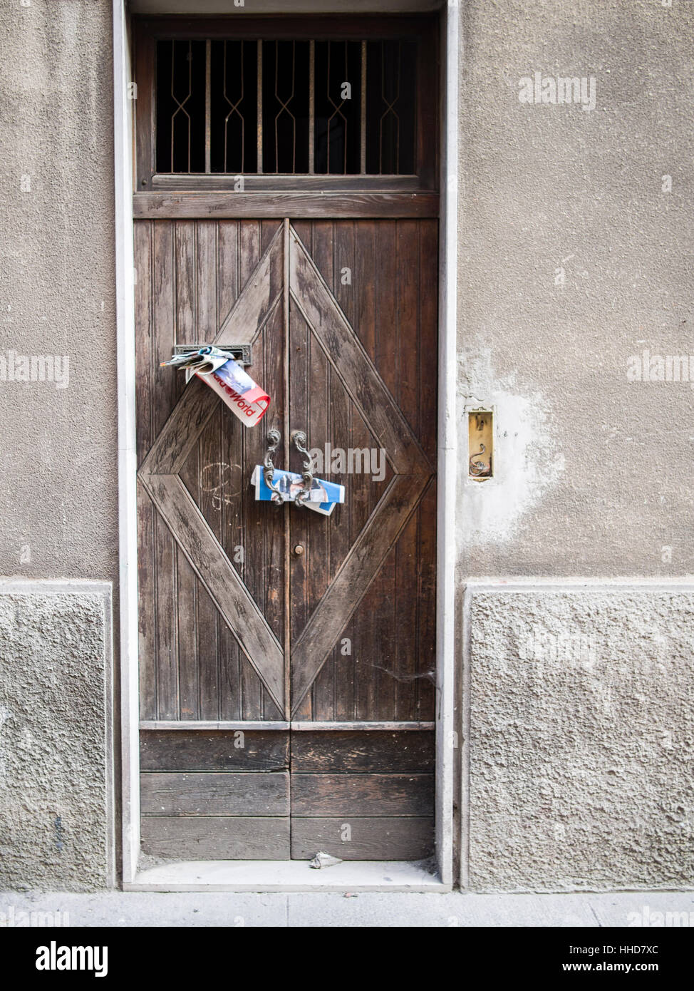 Junk mail in door handle or posto boxes in Italy. Stock Photo