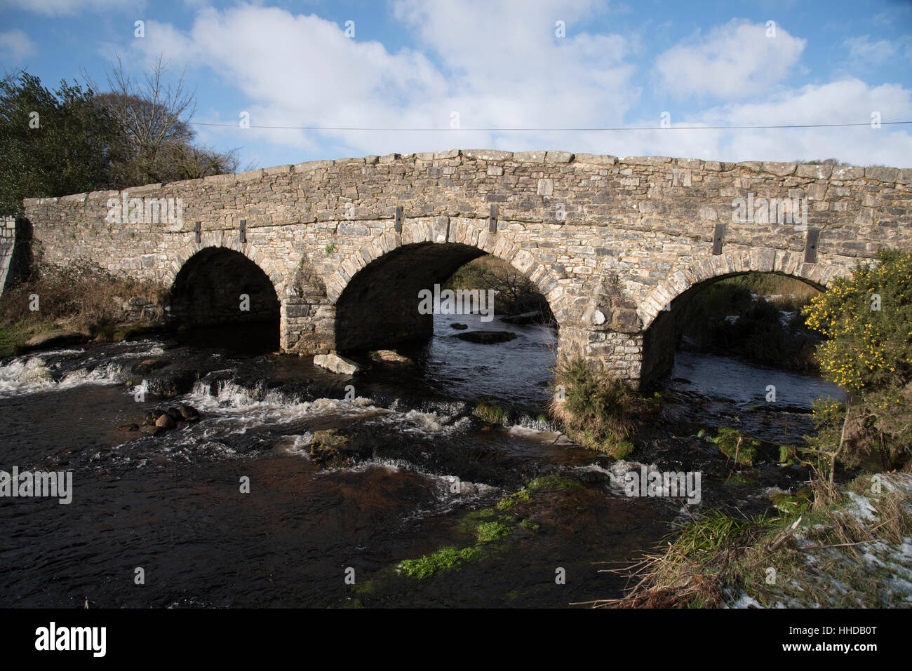 The  East Dart River and road bridge built in the 1700's at Postbridge on Dartmoor in Devon England UK Stock Photo