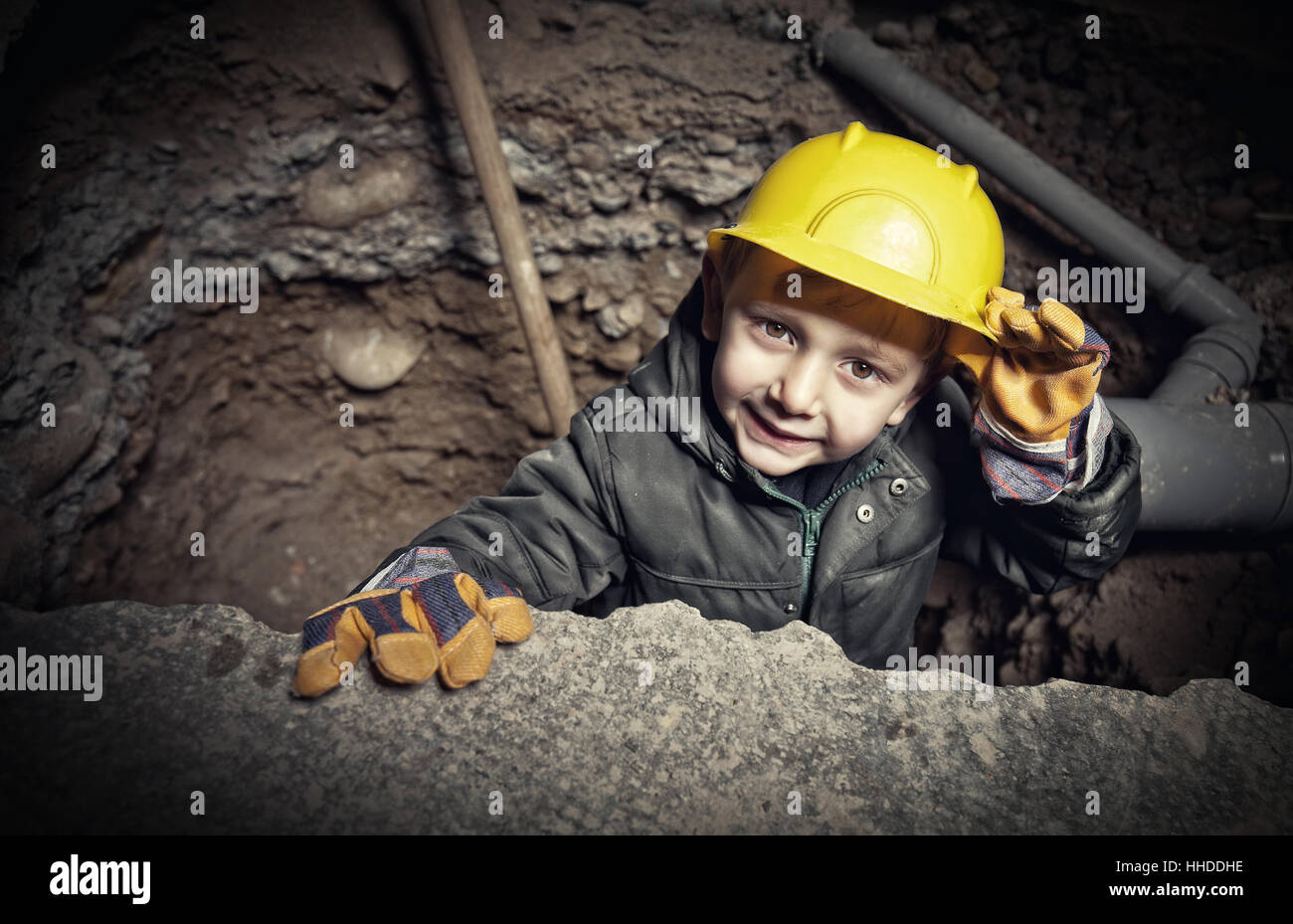 little handyman at work in construction site Stock Photo