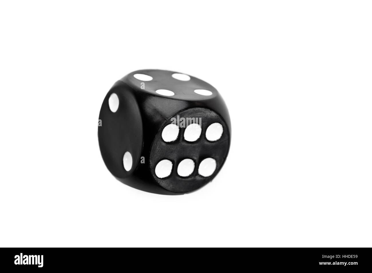 Black dice in motion against a white background Stock Photo Alamy