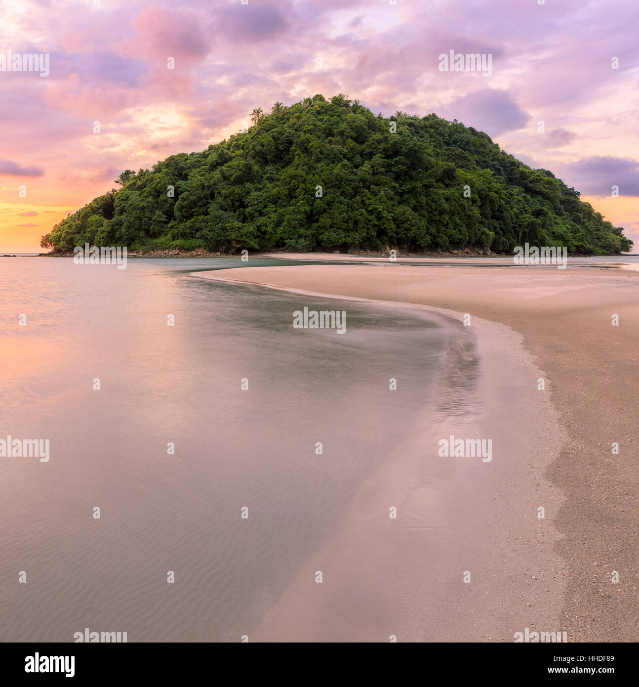 Tropical island and paradise beach at sunset Stock Photo Alamy