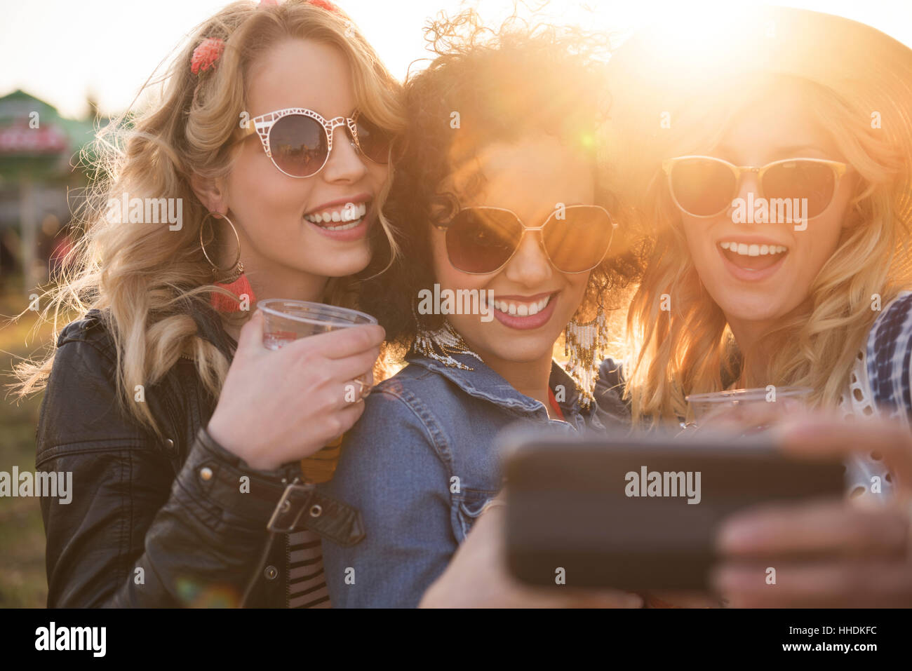 Taking many selfies with mobile phone Stock Photo