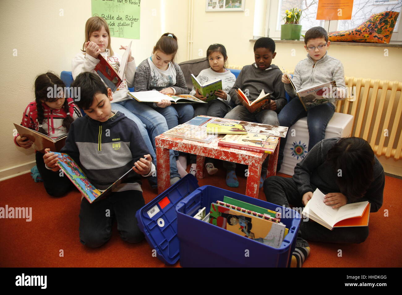 Pupils at a primary school read books about the live in Africa. Stock Photo