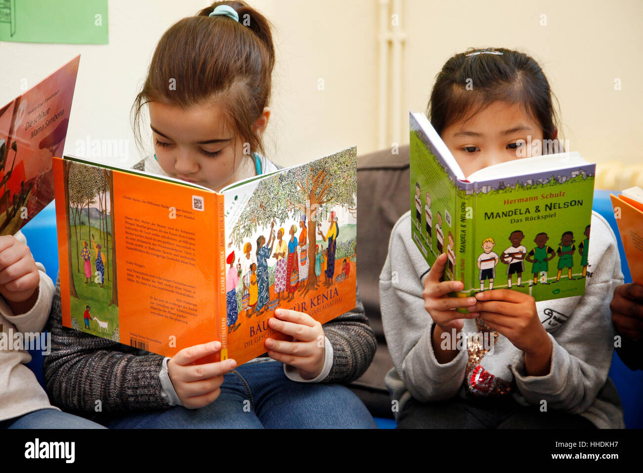 Pupils at a primary school read books about the live in Africa. Stock Photo