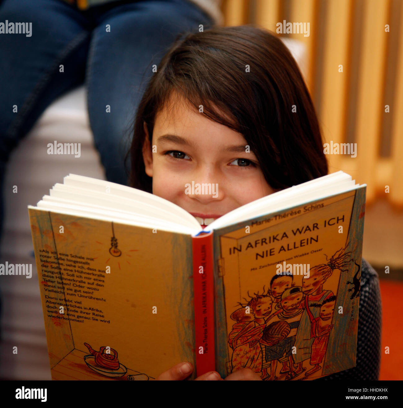 Pupils at a primary school read books about the live in Africa. Stock Photo