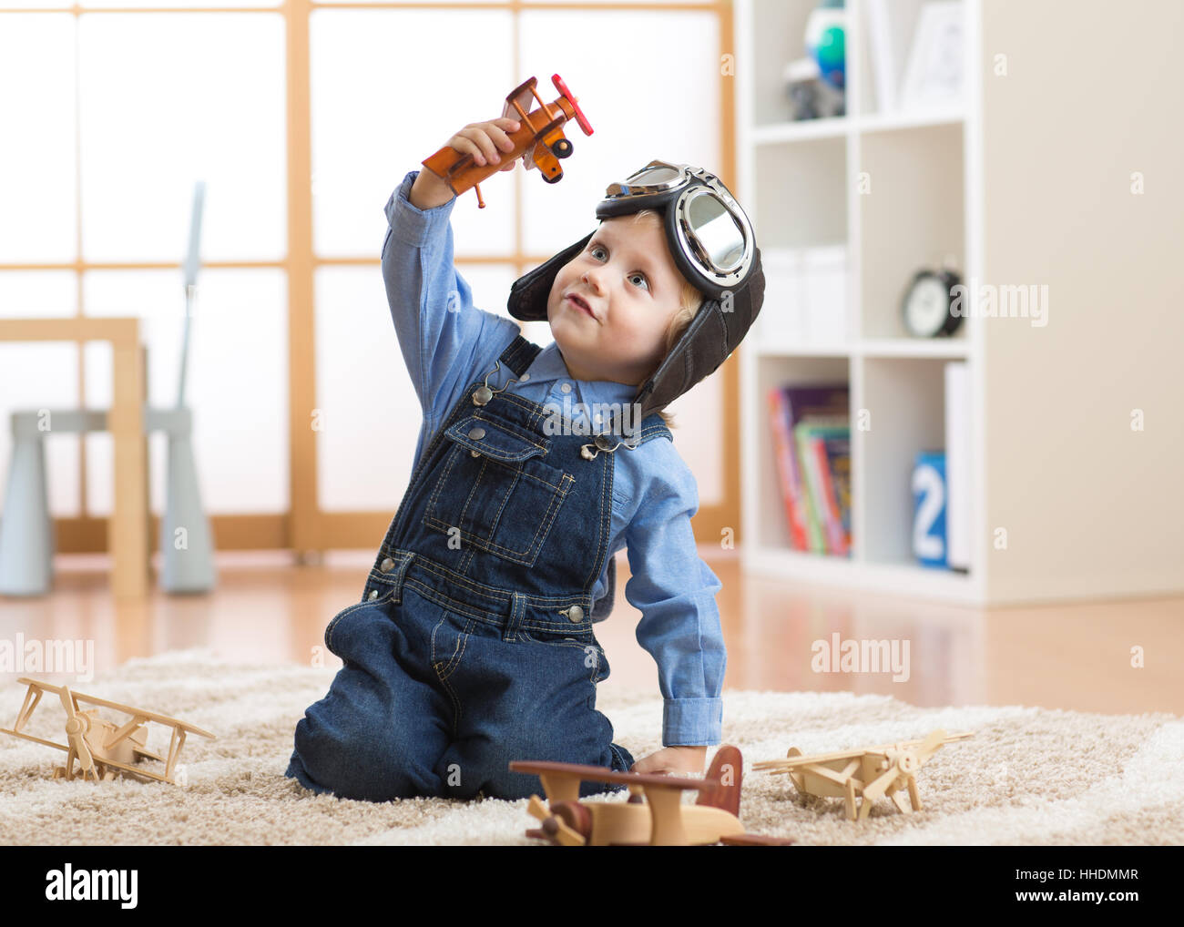 happy child toddler boy playing with toy airplane and dreaming of becoming a pilot Stock Photo