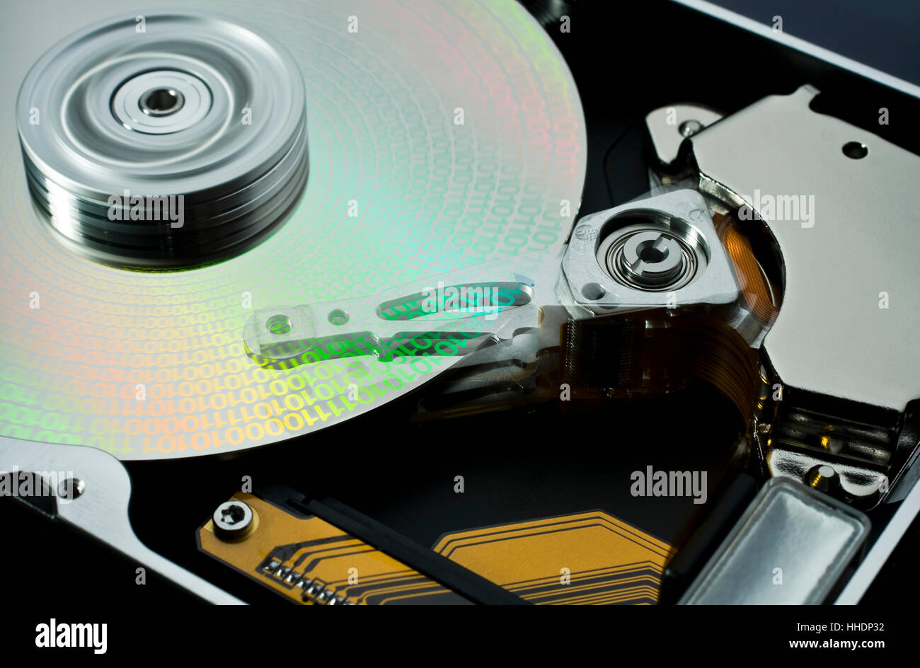 studio photography of a opened hard disk at work with symbolic data Stock Photo