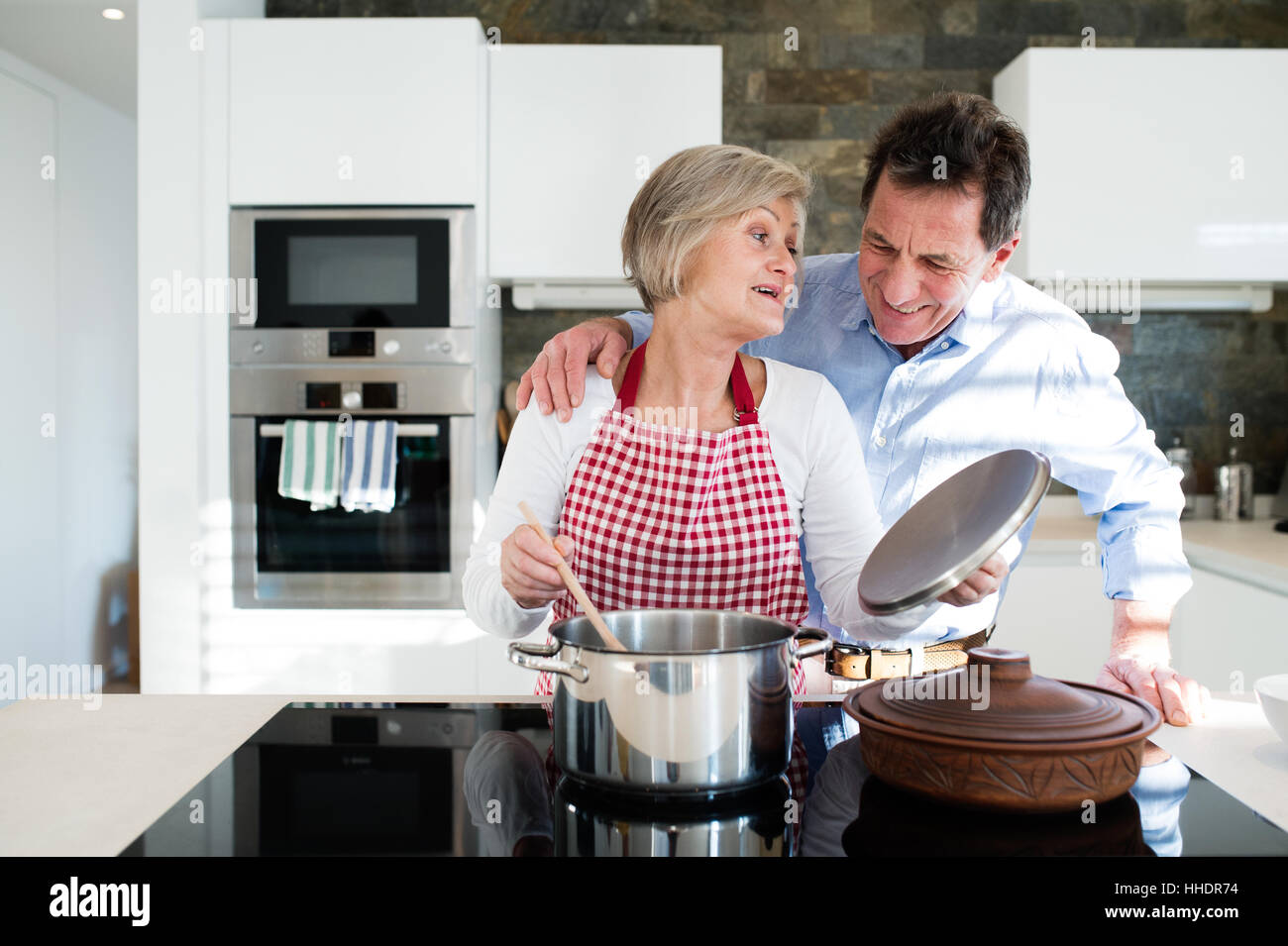 Senior couple in the kitchen cooking together Stock Photo - Alamy