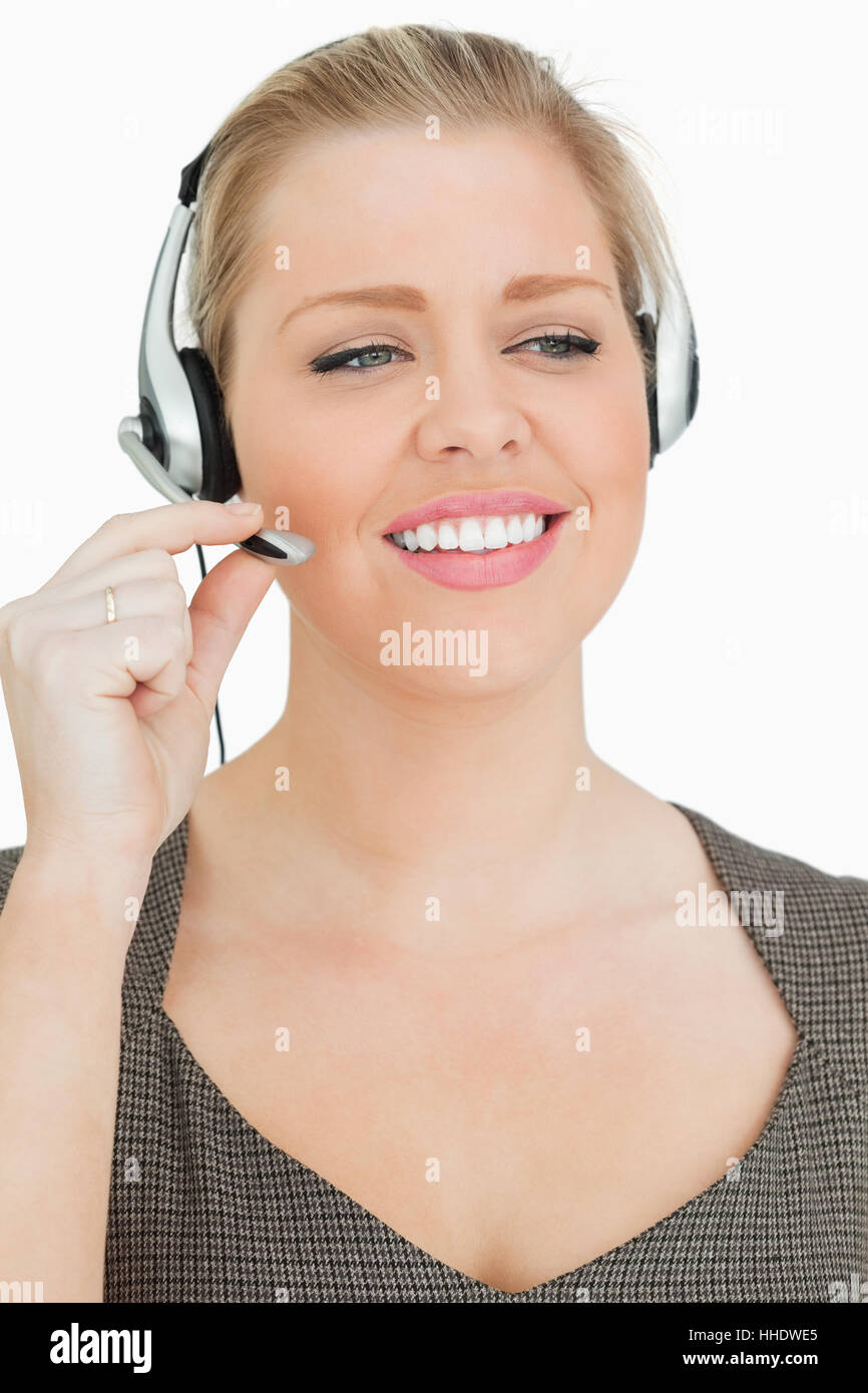 Pretty woman working in a call center against white background Stock ...