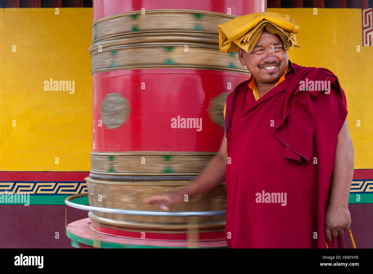 A Buddhist monk (lama) spins a prayer wheel at Diskit Monastery in the