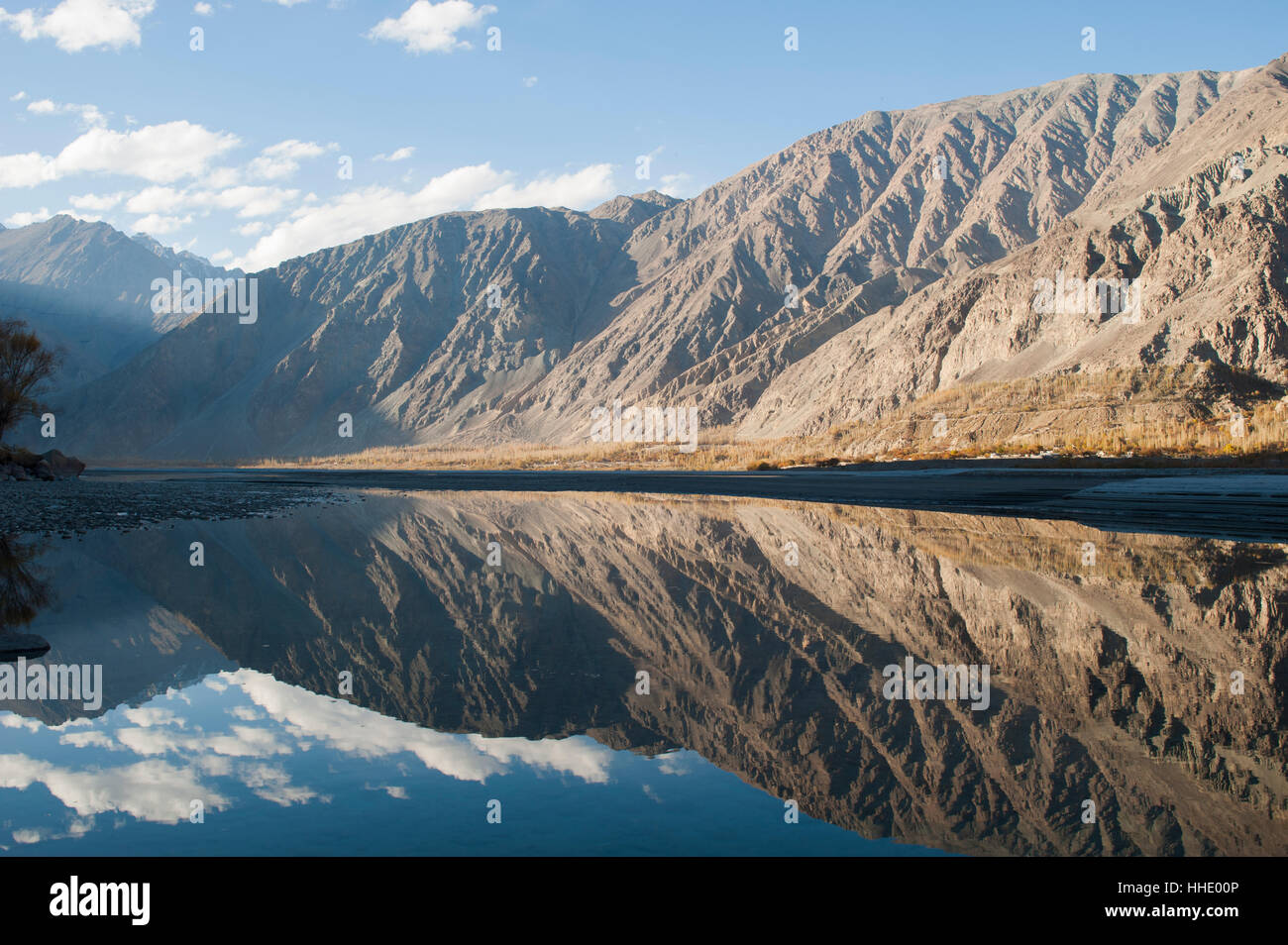 The crystal clear Shyok River creates a mirror image in the Khapalu valley near Skardu, Gilgit-Baltistan, Pakistan Stock Photo