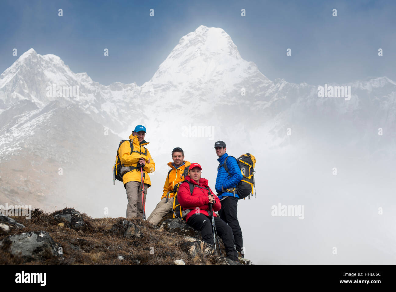 A team of four climbers make their way to Ama Dablam Base Camp, the 6856m peak seen in the distance, Khumbu Region, Nepal Stock Photo
