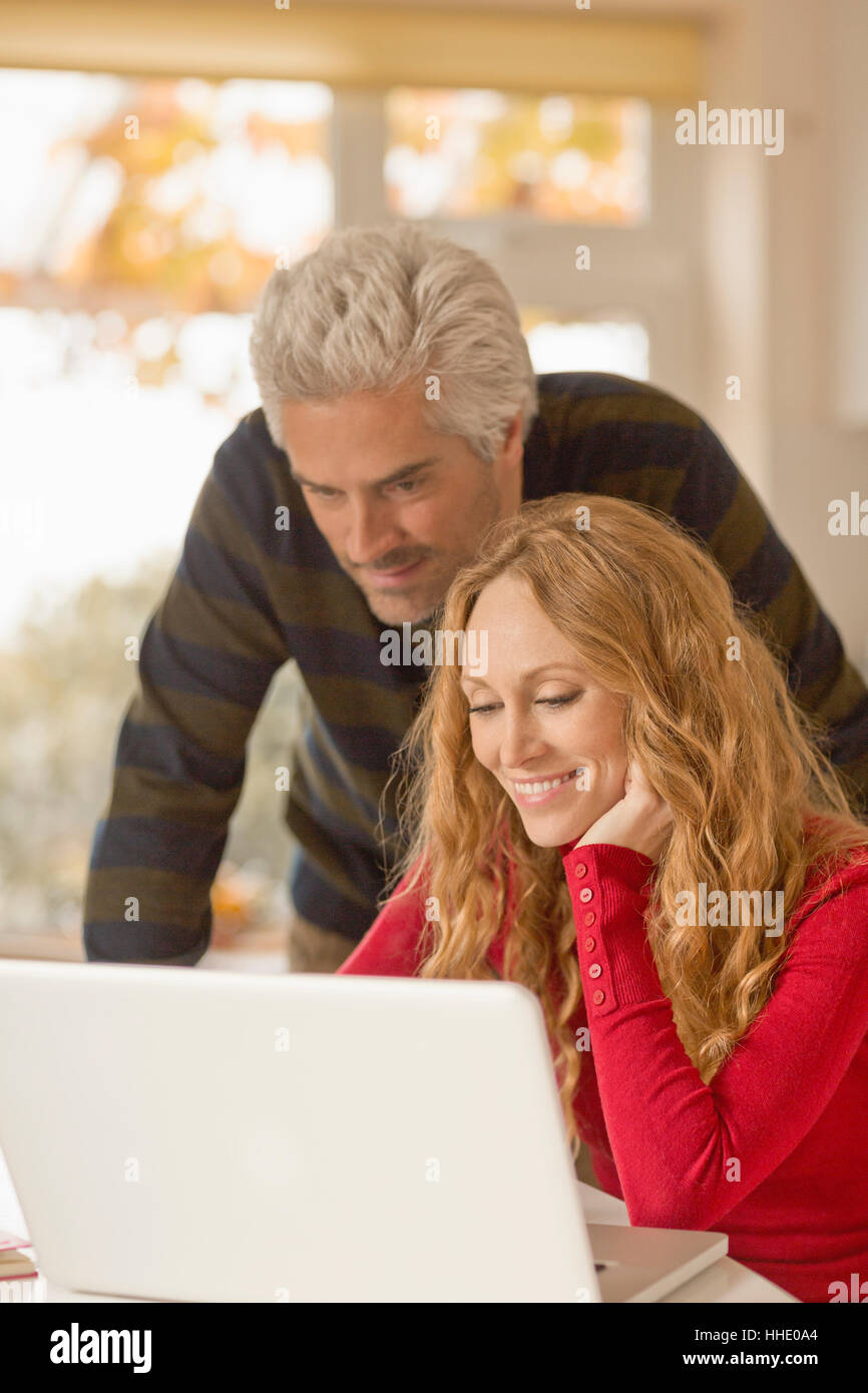 Couple using laptop at home Stock Photo