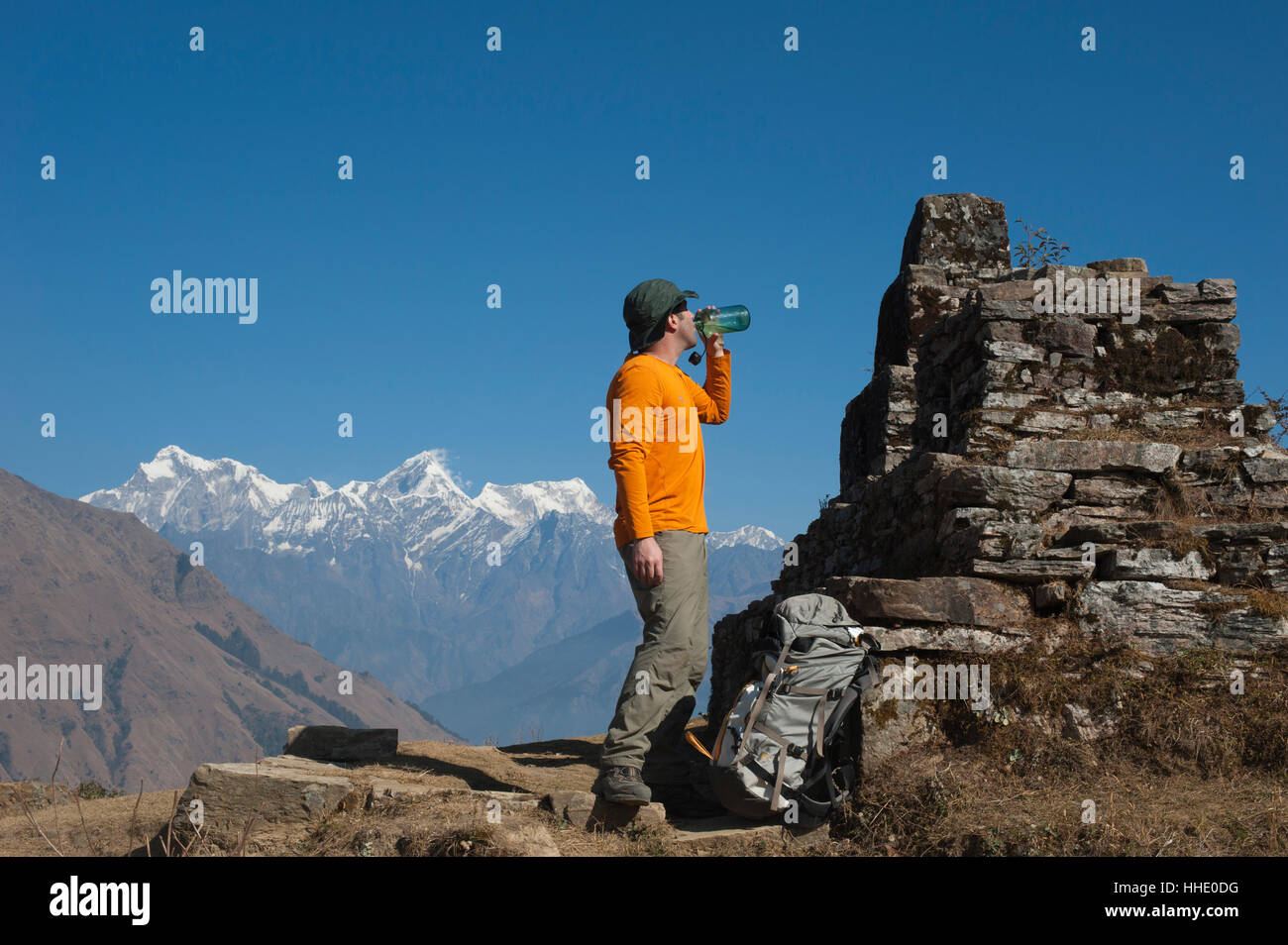 A trekker takes some well earned refreshment during the Manaslu circuit trek, Nepal Stock Photo