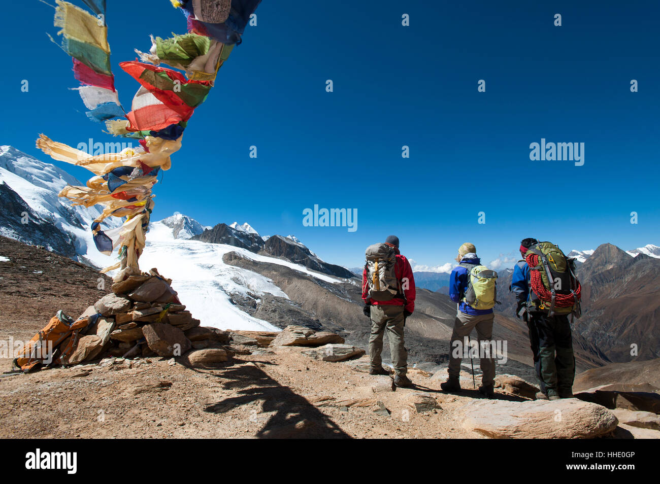 A windy prayer flag strewn cairn marks the top of the Kagmara La, the highest point in the Kagmara Valley, Dolpa Region, Nepal Stock Photo