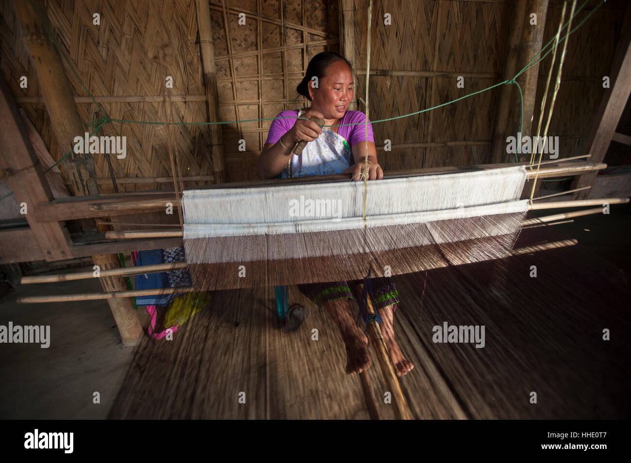 Weaving a Punin on a traditional hand loom, Assam, India Stock Photo