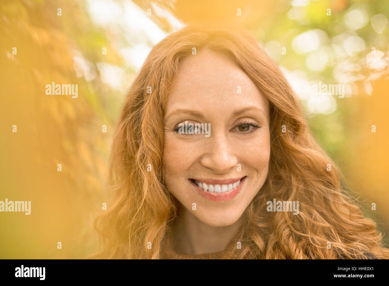 Close up portrait smiling woman with red hair Stock Photo
