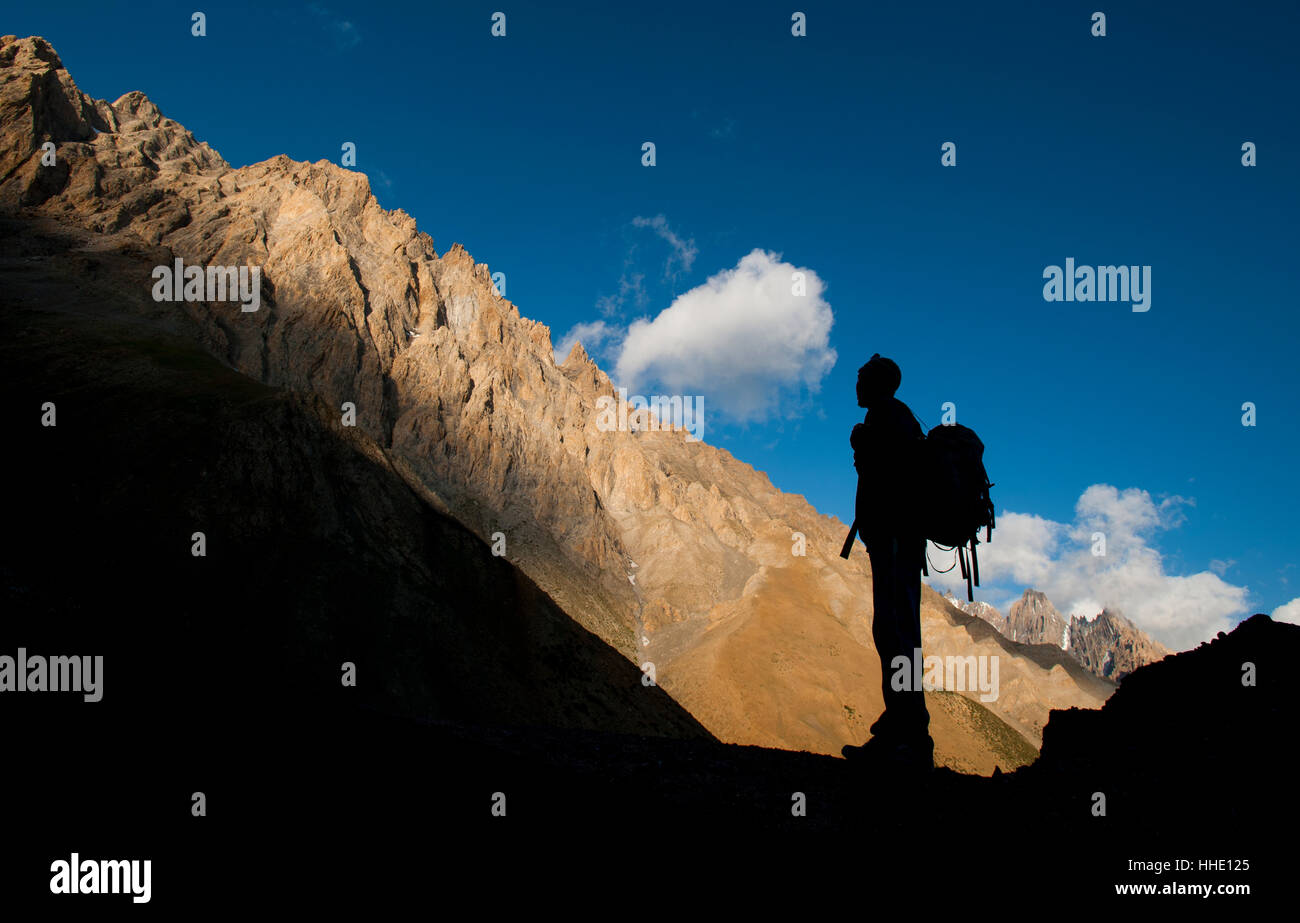 A trekker takes in the dramatic scenery from near the top of the Dung Dung La, during the Hidden valleys trek, Ladakh, India Stock Photo