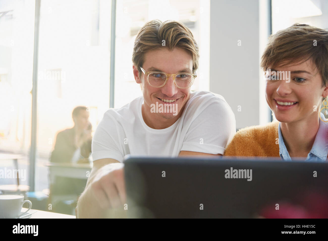 Business people using laptop in cafe Stock Photo - Alamy