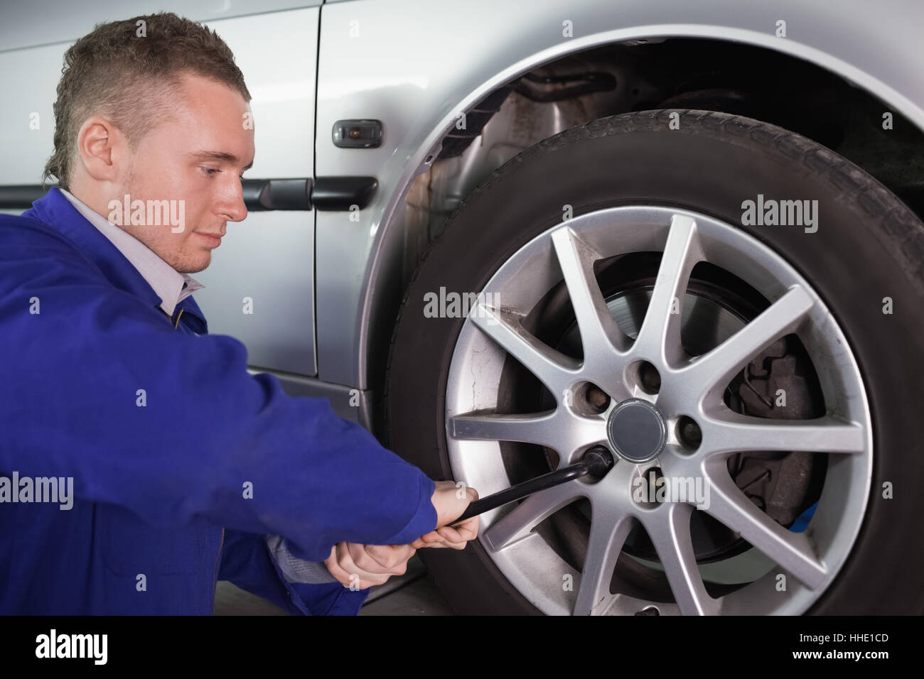 Man repairing a car wheel in a garage Stock Photo - Alamy