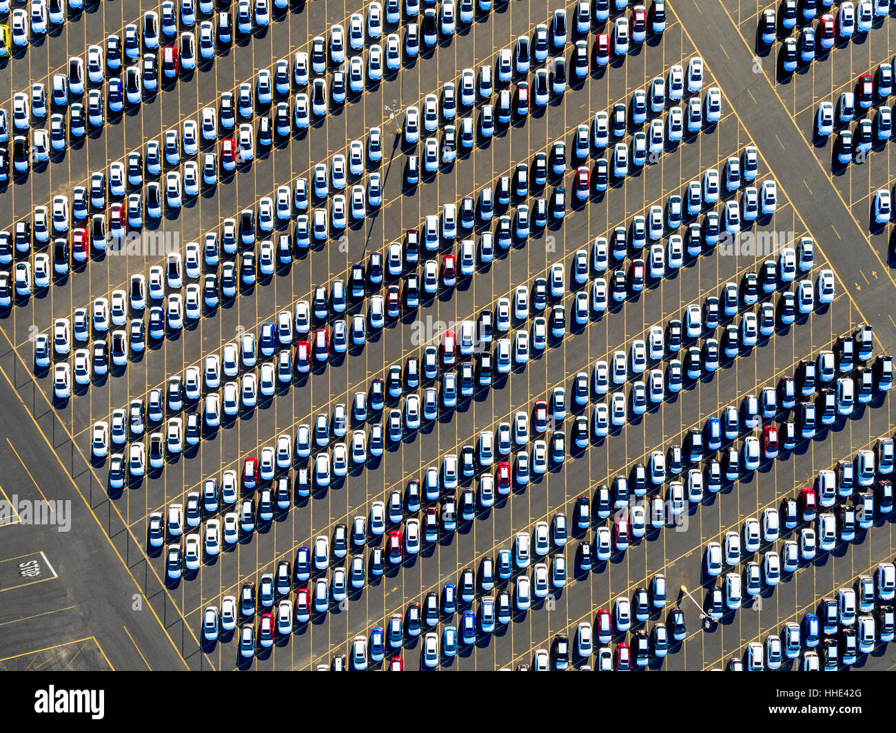 Aerial view of a car distribution centre, new cars parked in rows on a lot ready for sale. Stock Photo