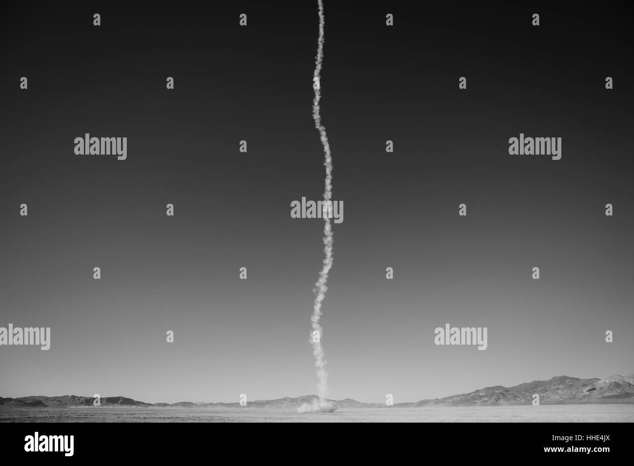 Smoke trail from amateur rocket shooting into sky, Black Rock Desert, Nevada Stock Photo