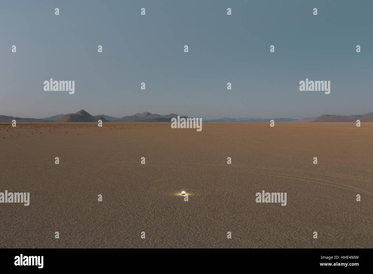 Small glowing light on vast playa, Black Rock Desert, Nevada Stock Photo