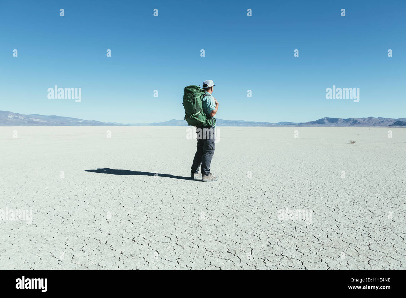 Male backpacker hiking in vast desert, Black Rock Desert, Nevada Stock Photo