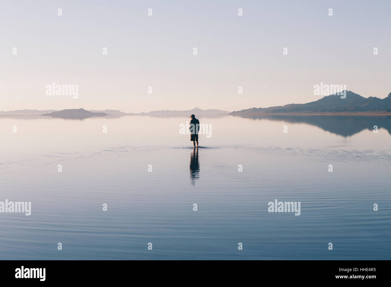 Man walking on vast and flooded Bonneville Salt Flats, Utah Stock Photo