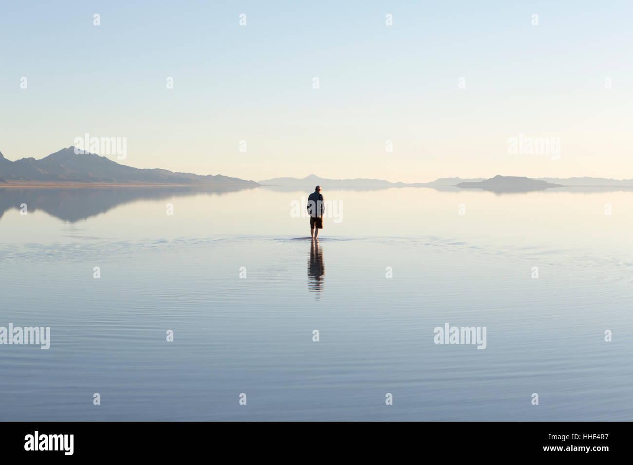 Man walking on vast and flooded Bonneville Salt Flats, Utah Stock Photo