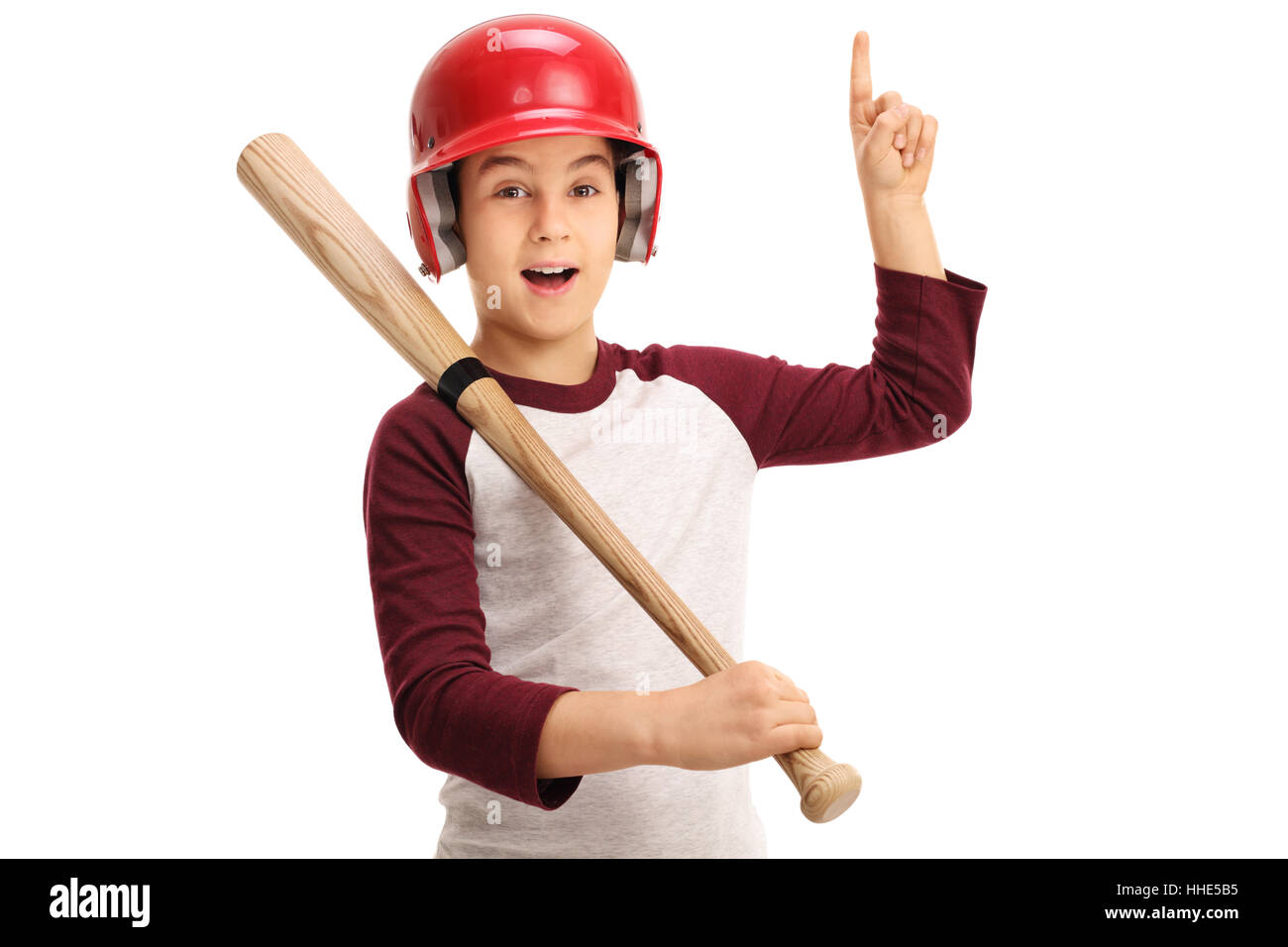 Joyful kid with baseball equipment pointing up isolated on white background Stock Photo